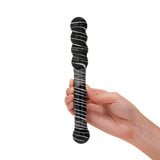 striped dual-ended glass dildo with both beaded and round tip held in a hand against a white background