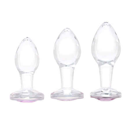 Scale Reference: Three clear glass pink-gem plugs grouped together to illustrate Small, Medium, and Large sizes.

