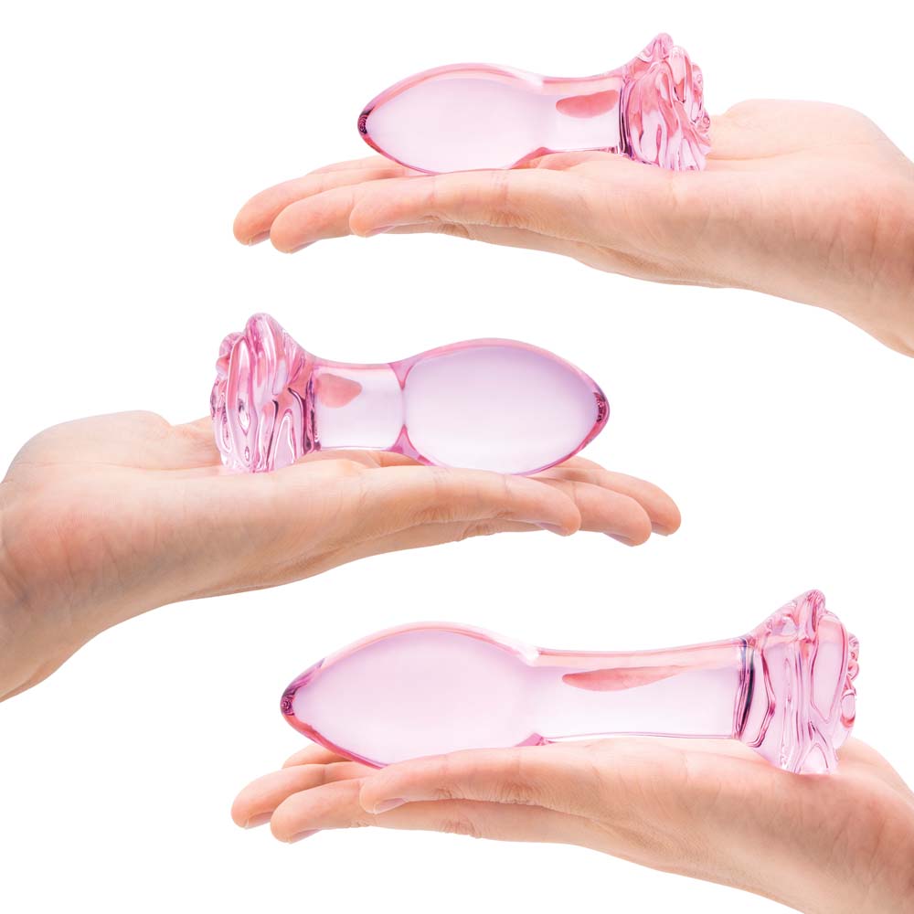 Model holding the small, medium and large size Rosebud Anal Plug as part of the 3 Piece Gläs Rosebd Butt Plug Set