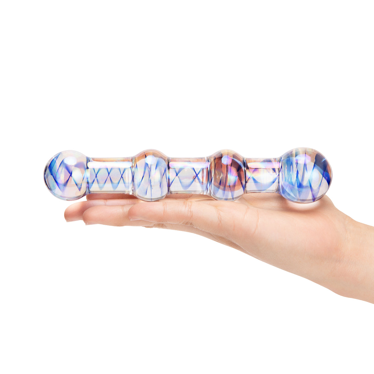 Glass dildo with blue and purple pattern held in a hand on a white background