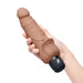 Model holding the Powercocks 7" Realistic Vibrator With Clitoral Stimulator in Mocha color