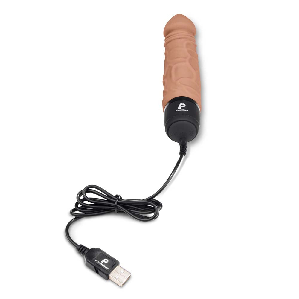 USB pin charger plugged into the charging port located at the bottom of the Powercocks 6.5" Realistic Vibrator in Mocha color
