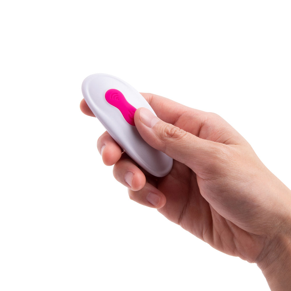 Model holding the remote control of the Together Vibes Internal Kisses Remote Controlled Vibrator