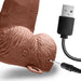 Close up image of the power button and charging cable plugging into the charging port of the Lux Fetish 6 inches Rechargeable Strap-On With Balls in Brown color